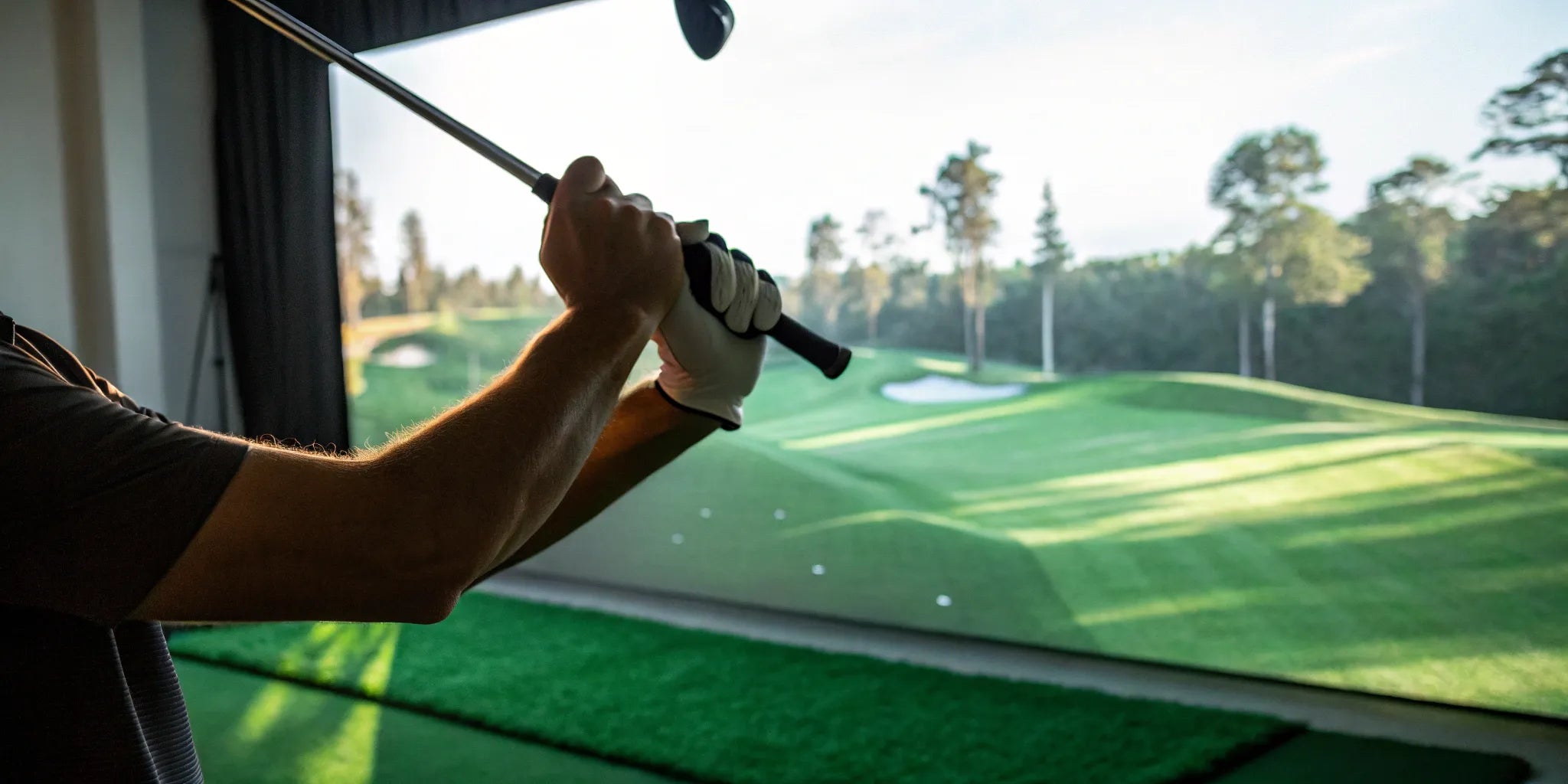 Golfer analyzing their golf swing speed on a monitor app indoors.