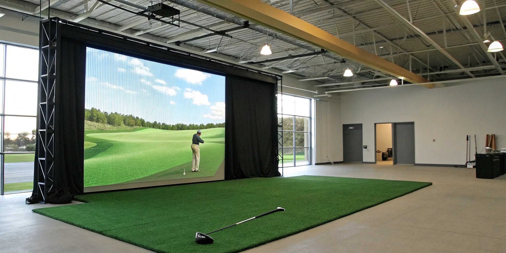 A professional commercial golf simulator installation inside a dedicated indoor golf room.