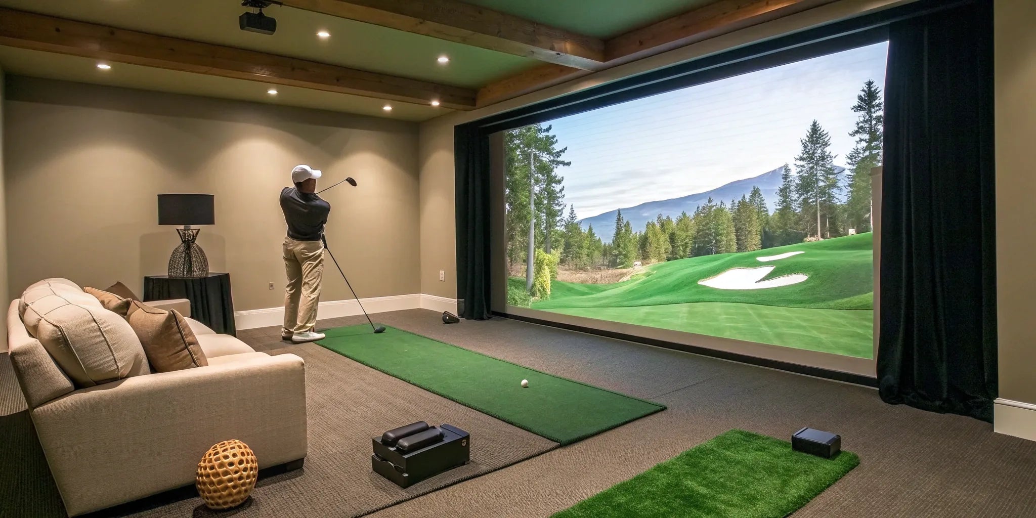 A man uses a golf simulator for indoor use, complete with a hitting mat and large screen.