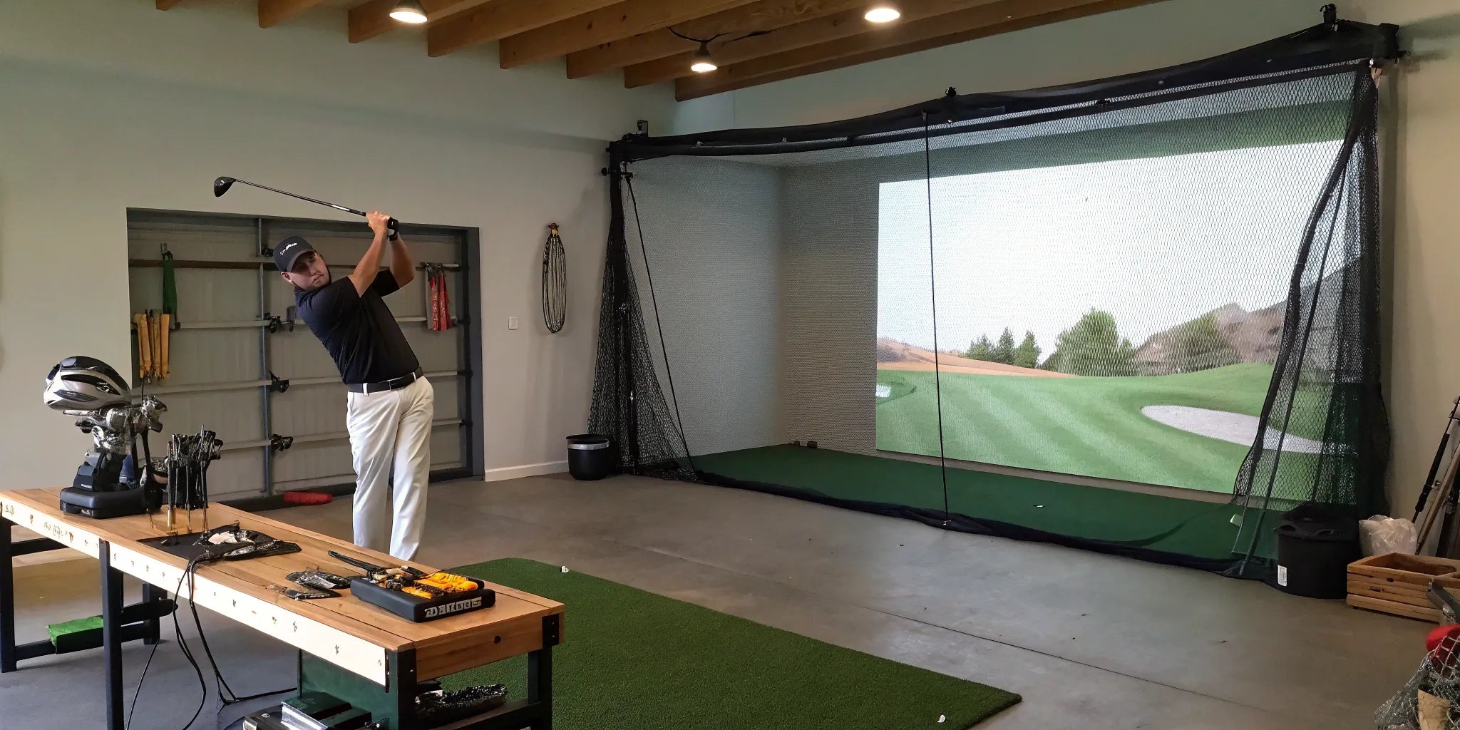 Golfer takes a swing in a home golf simulator built on a budget.